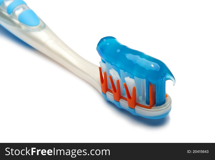 The picture shows a toothbrush with toothpaste. The picture shows a toothbrush with toothpaste