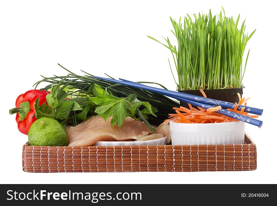 Raw chicken breast and vegetables on a brown tray. Raw chicken breast and vegetables on a brown tray.