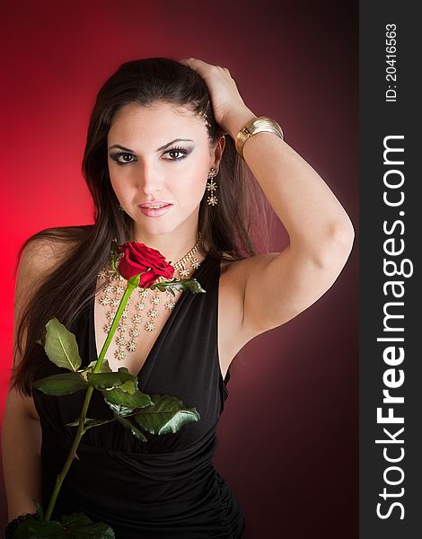Portrait of young beautiful woman and red rose