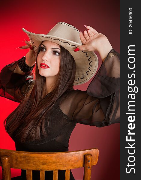 Portrait lady in a cowboy hat in studio