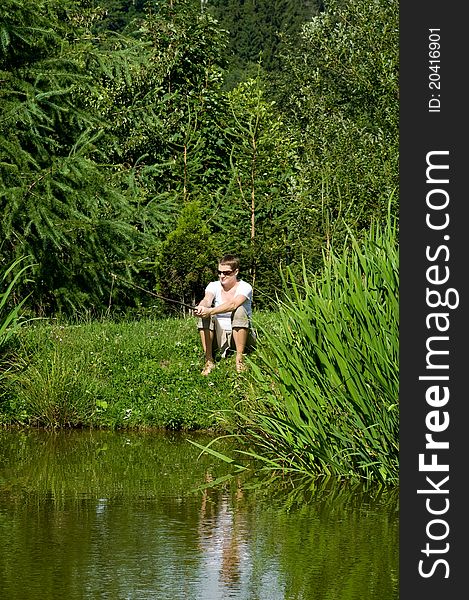 Green water of the pond and woman fishing. Green water of the pond and woman fishing