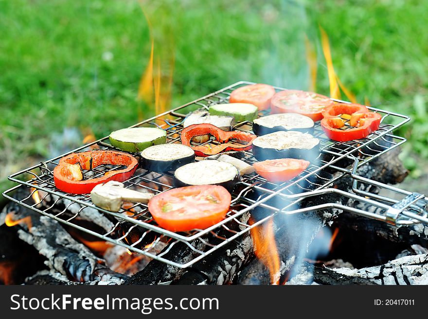 An image of a grill with vegetables on it. An image of a grill with vegetables on it