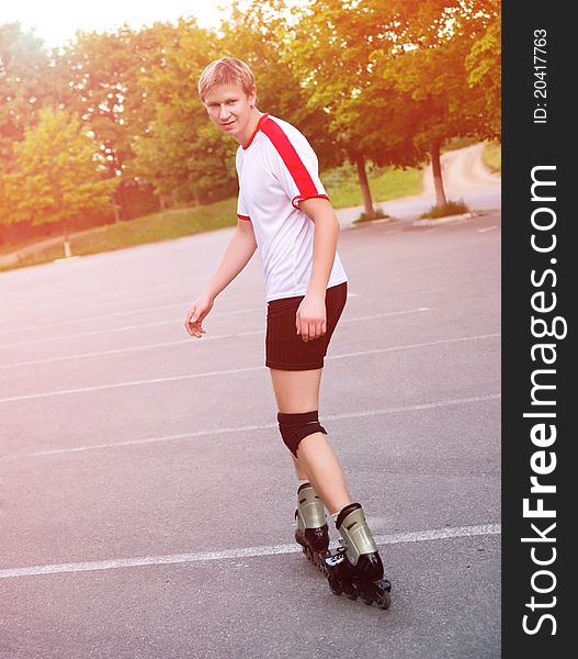 Young active roller blade skater on the park