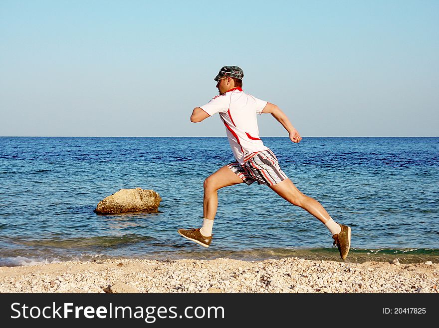 Man is running on a beach. Man is running on a beach