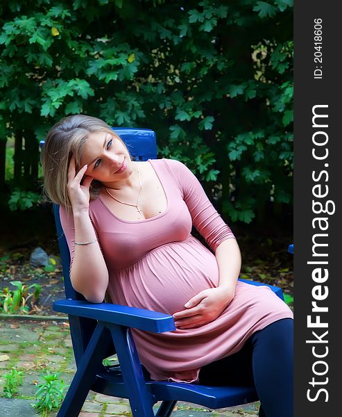 Pregnant woman waiting in garden