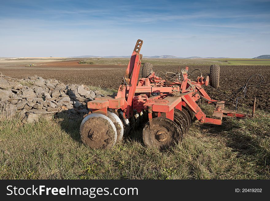 Disk Ripper in the field. Plough is a tool used in farming for in initial cultivation of soil