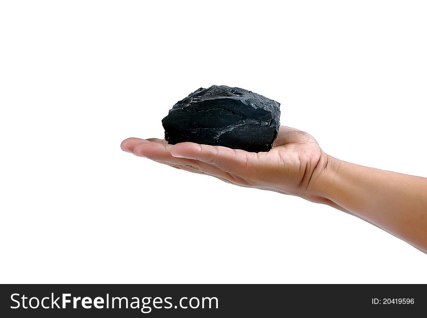 Male hand holding a little lump of coal  isolated on white background