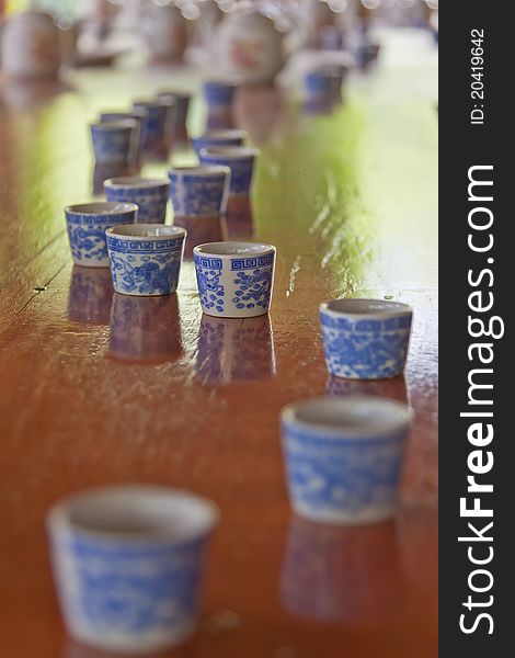Cups and teapots on a table after a tea ceremony outdoors. Cups and teapots on a table after a tea ceremony outdoors