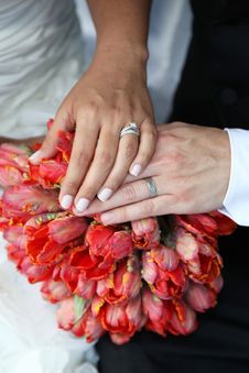 Wedding Hands And Rings On Bouquet Stock Image