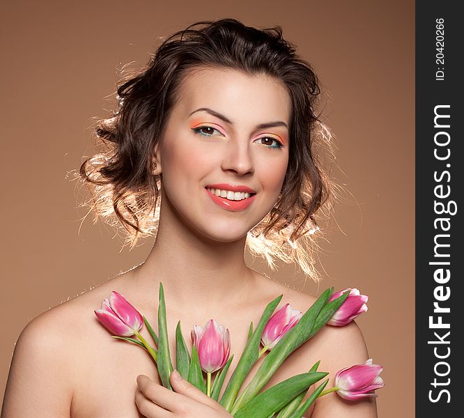 Portrait of a beautiful girl with tulips