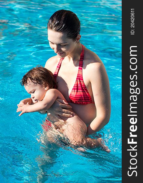 Mother with son in pool