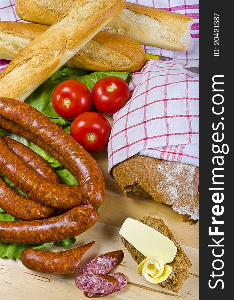 Tasty Polish sausage with bread, butter and vegetables