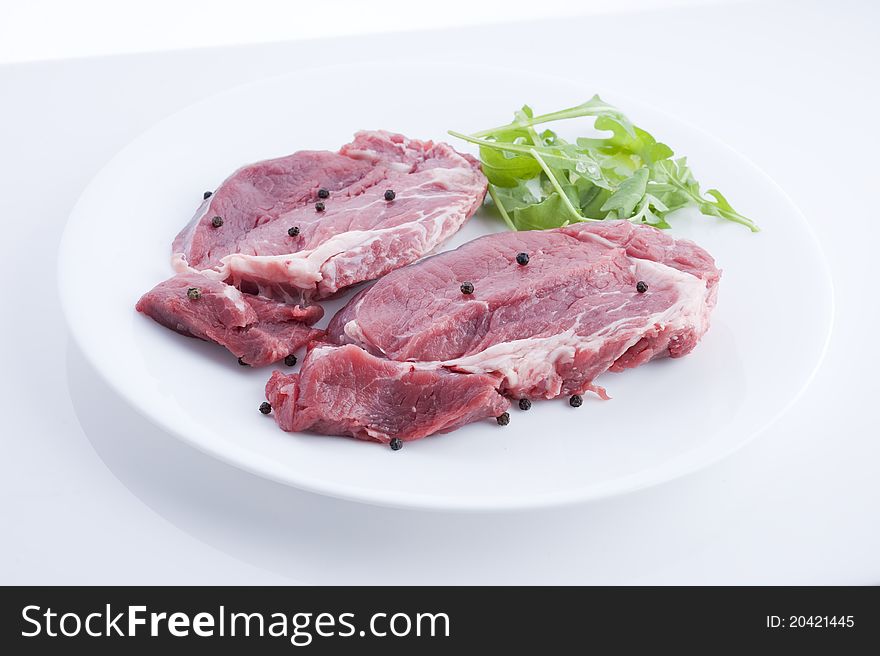 Fresh beef in the pot on a white background