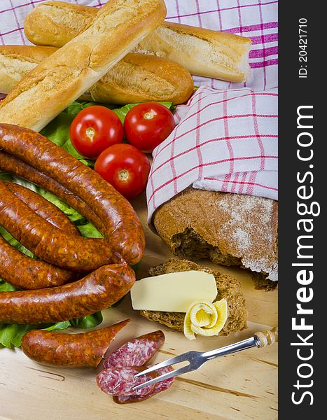 Tasty Polish sausage with bread, butter and vegetables