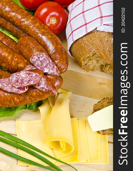 Tasty Polish sausage with bread, butter and vegetables