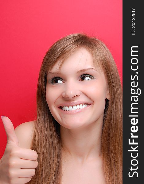 Portrait of a young woman on red