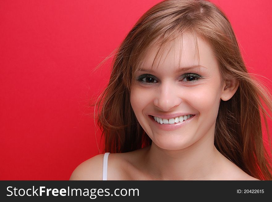 Portrait of a young woman on red