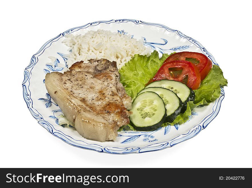 Meat with vegetables and rice on white plate