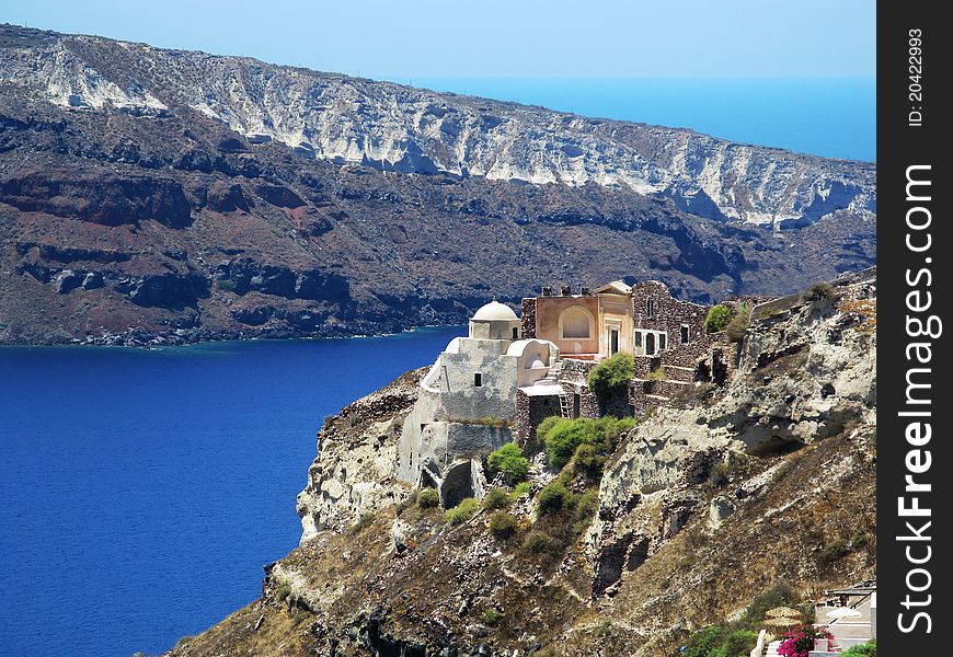 View to old church in Santorini island with background of blue sea and mountain. View to old church in Santorini island with background of blue sea and mountain