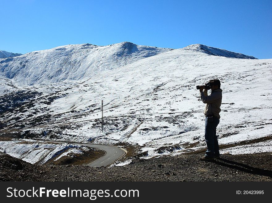 Photographer with camera taking pictures in the snow. Photographer with camera taking pictures in the snow