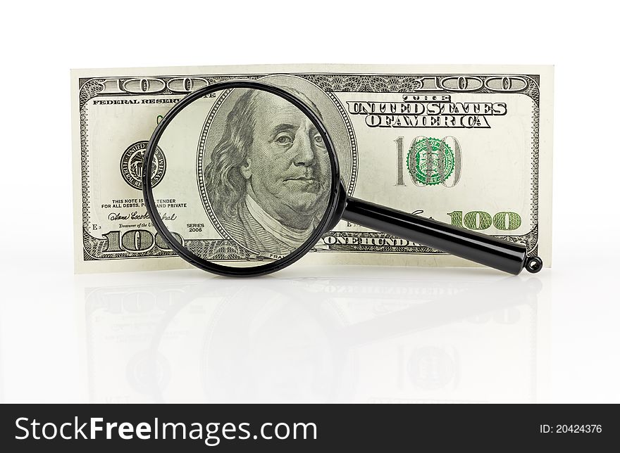 Dollars and magnifying lens. on white background