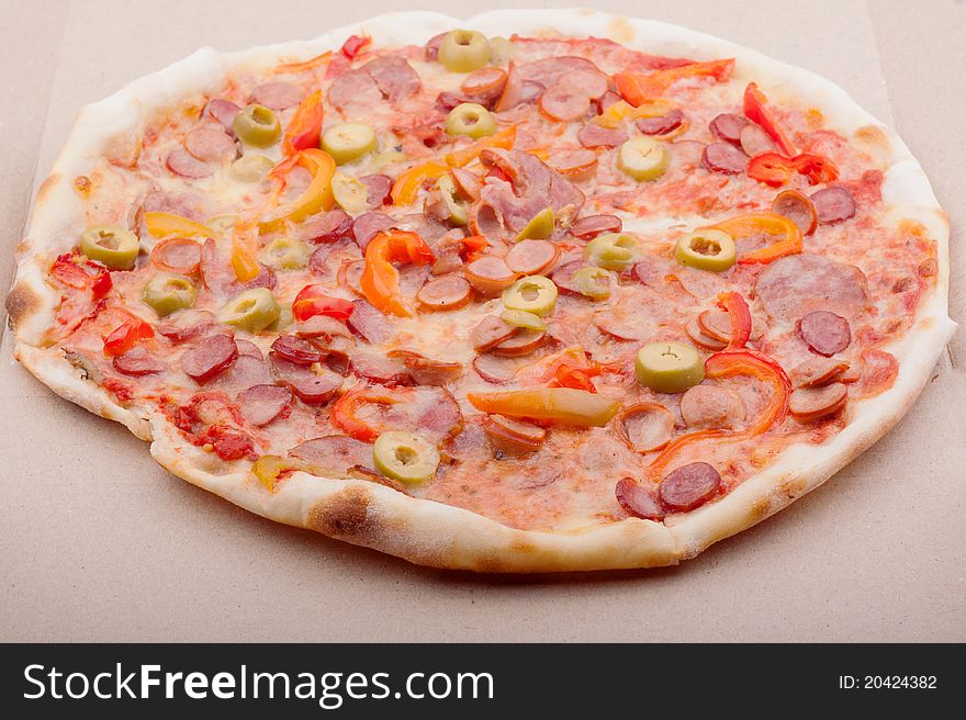 Hot and delicious pizza with meat and vegetables.
