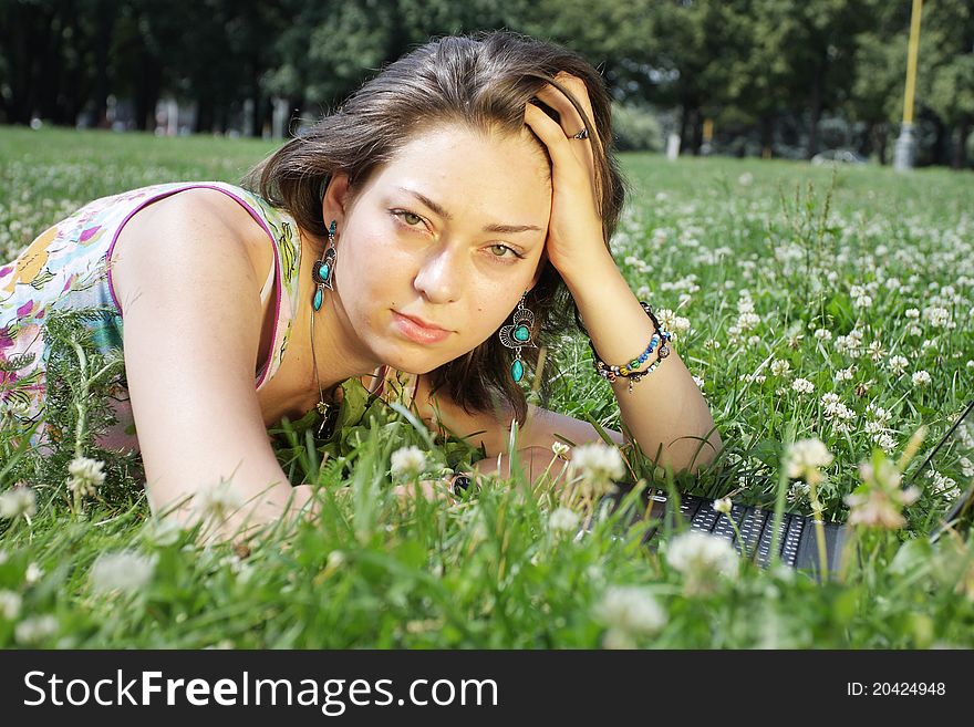 The image of a girl lies on a grass