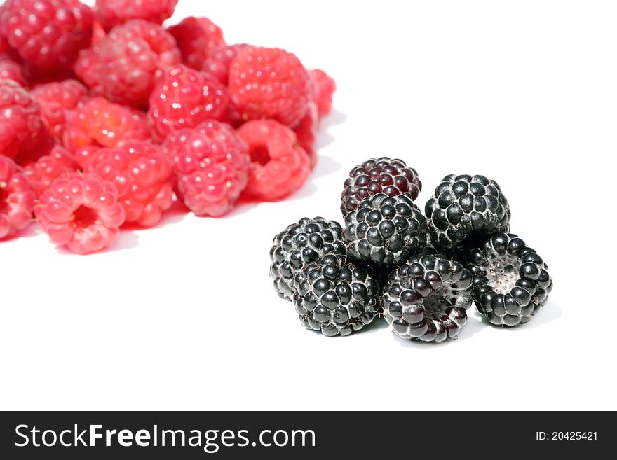 Fresh, juicy and healthy raspberries, red and black on white. Fresh, juicy and healthy raspberries, red and black on white