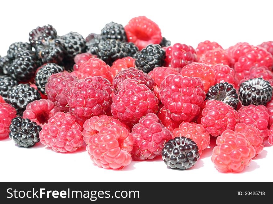 Fresh, juicy and healthy raspberries, red and black on white. Fresh, juicy and healthy raspberries, red and black on white