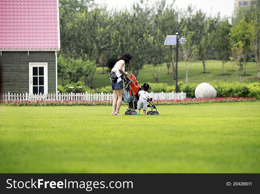 Mother And Daughter On The Lawn.