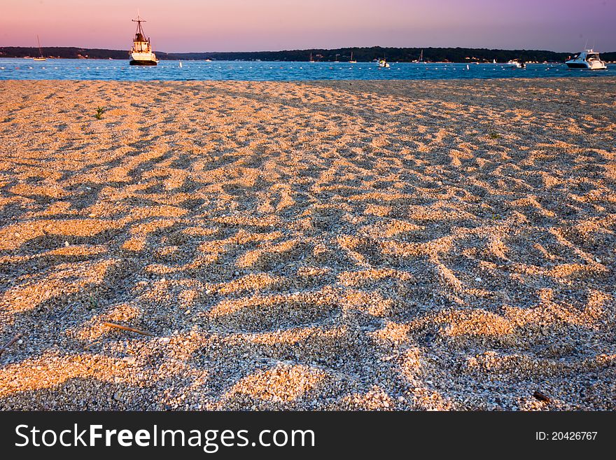 Fishing boat at the end of the day with golden sun falling on the beach