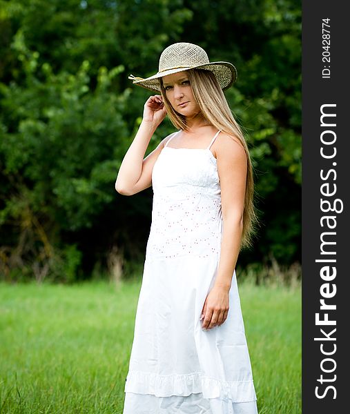 Young beautiful girl in straw hat