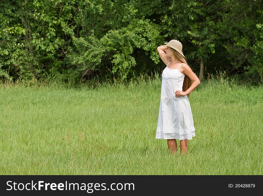 Young beautiful girl in straw hat