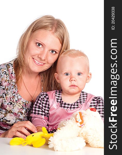 Happy mom with her daughter playing at table