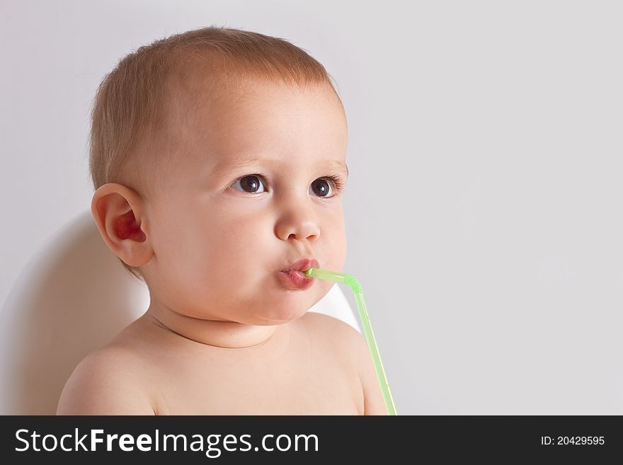 Baby drinking water with straw