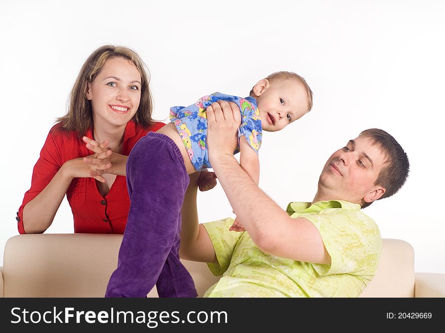 Pretty family on a sofa on a white. Pretty family on a sofa on a white