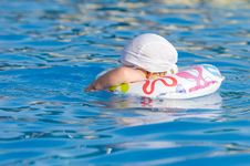 Baby In Inflatable Tube Is Swimming In Pool Royalty Free Stock Photo