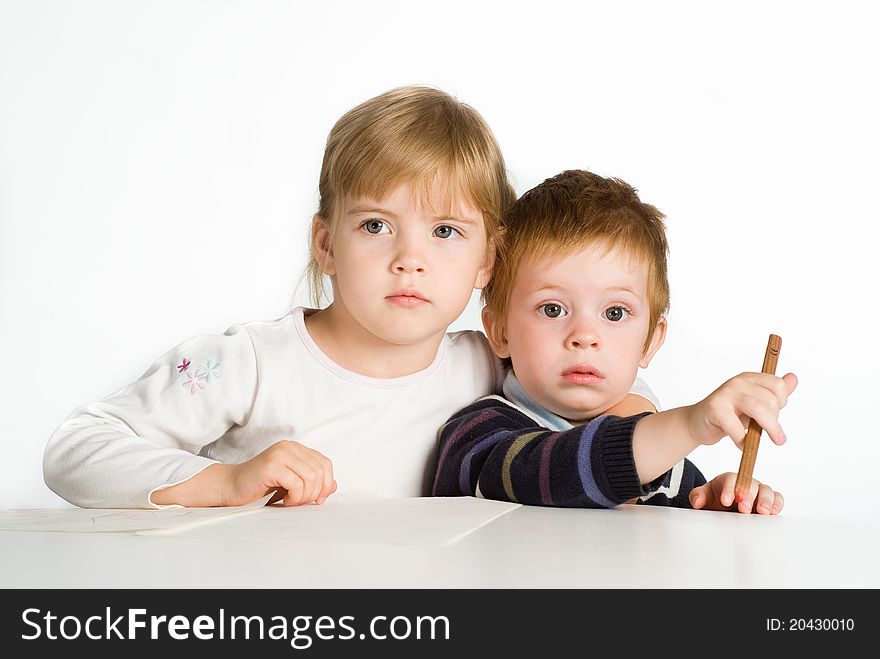 Children drawing at table on a white. Children drawing at table on a white