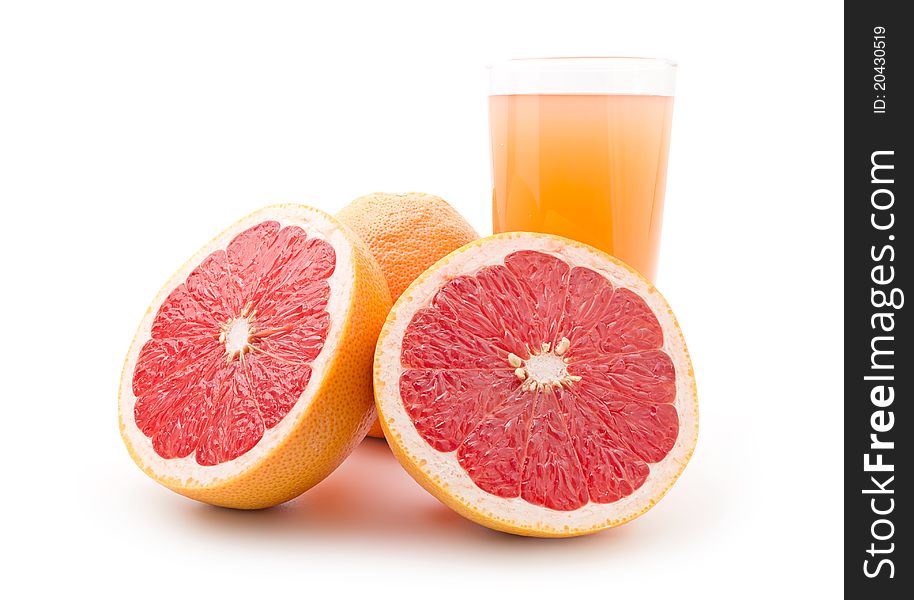 Ripe grapefruit and a glass of juice isolated on white background