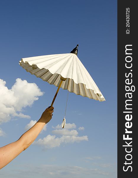 Woman hand holding white paper umbrella. Woman hand holding white paper umbrella