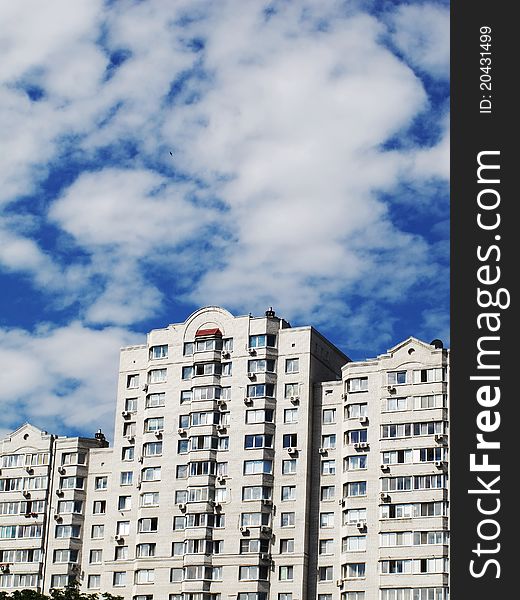 Modern apartment house against the sky with clouds in a city. Modern apartment house against the sky with clouds in a city