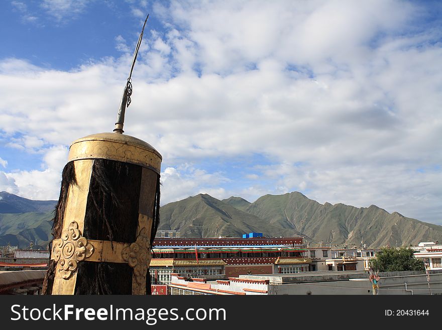 Tibetan Religious Symbol overlooking rooftops of Lhasa. Tibetan Religious Symbol overlooking rooftops of Lhasa