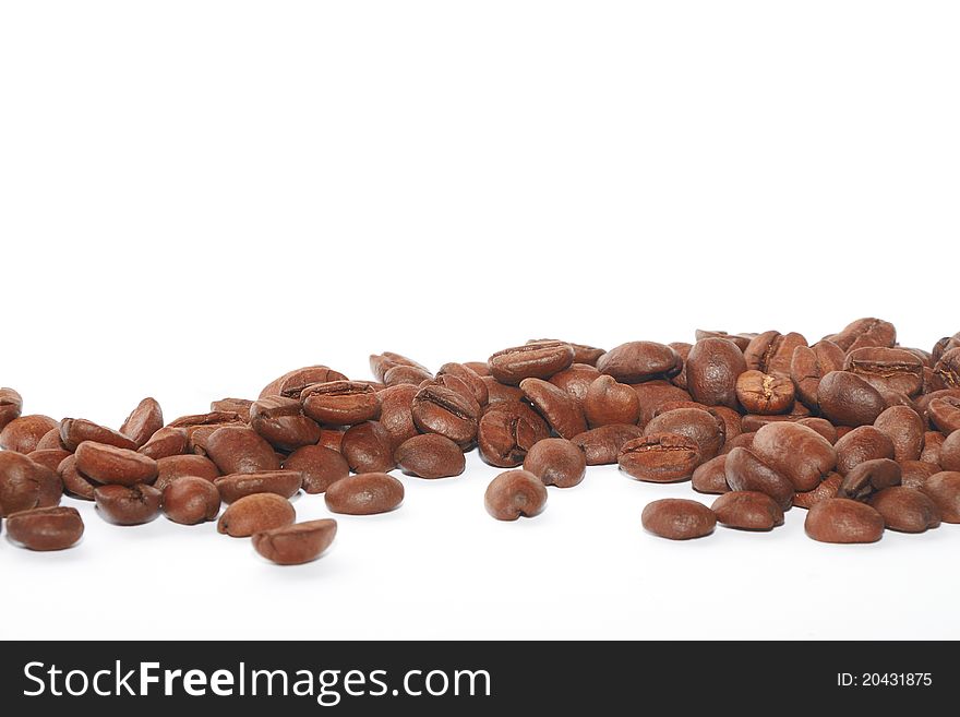 Brown coffee beans on the white background