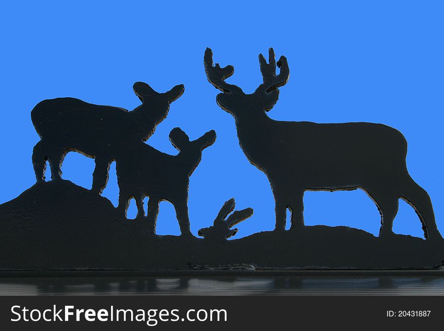 Mailbox decoration: a family of deer in silhouette against a blue sky. Mailbox decoration: a family of deer in silhouette against a blue sky