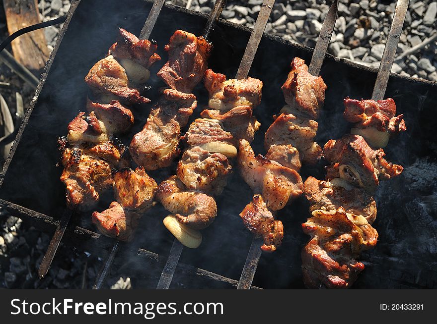 Fried meat on the grill with onions on skewers, barbecue. Fried meat on the grill with onions on skewers, barbecue