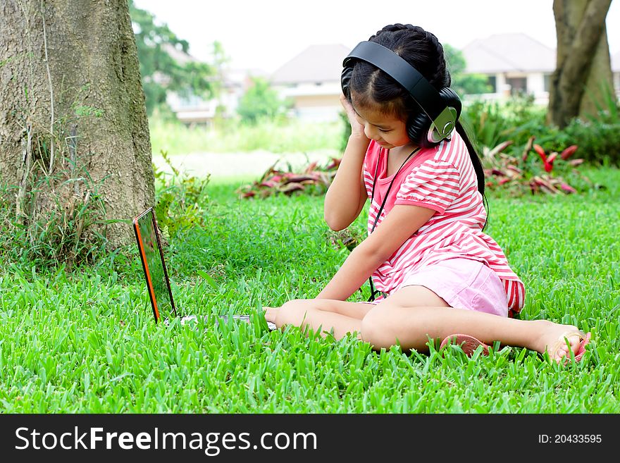 Girl listening to music. From a notebook in the garden. Girl listening to music. From a notebook in the garden