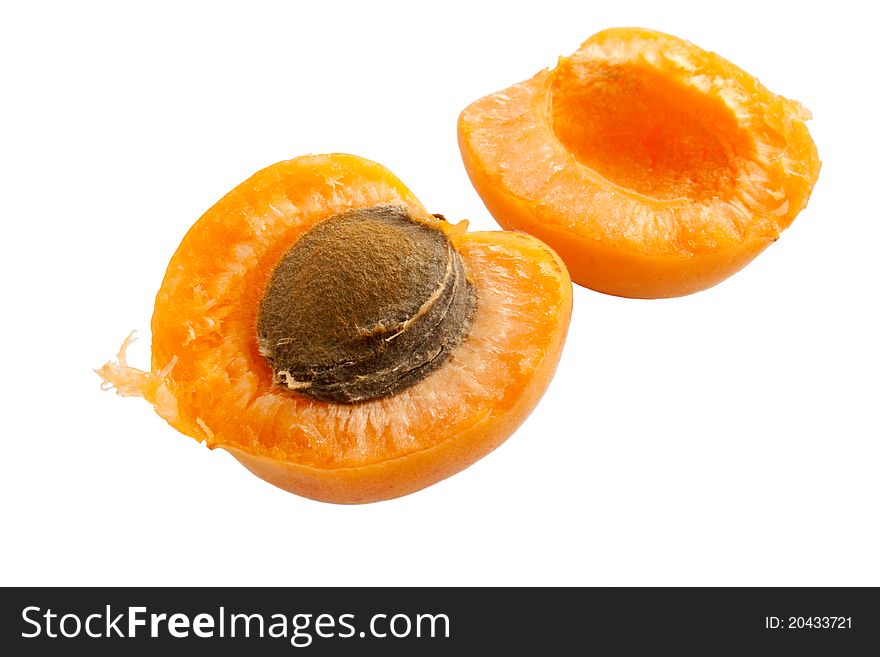 Apricot cut into half with seed inside isolated ovet white. Apricot cut into half with seed inside isolated ovet white