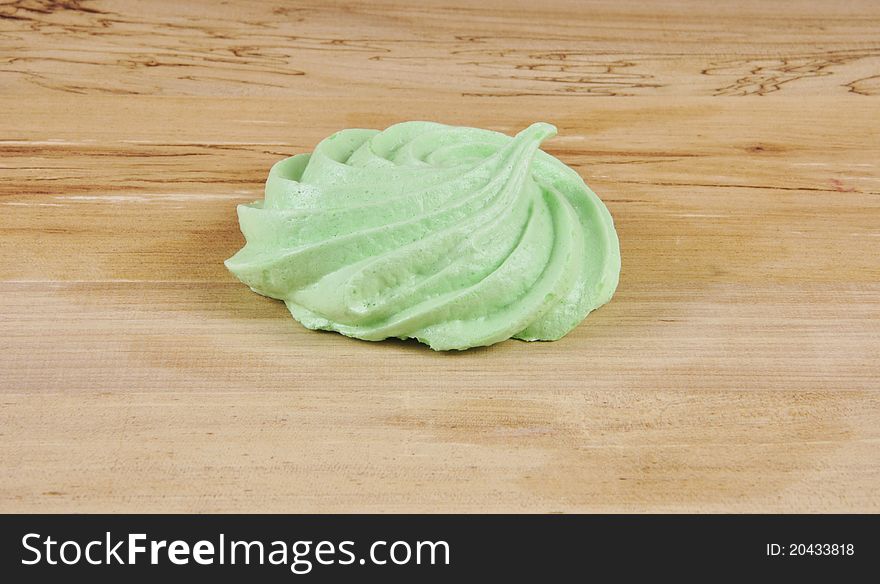 A green Meringue on a kitchen table. A green Meringue on a kitchen table.