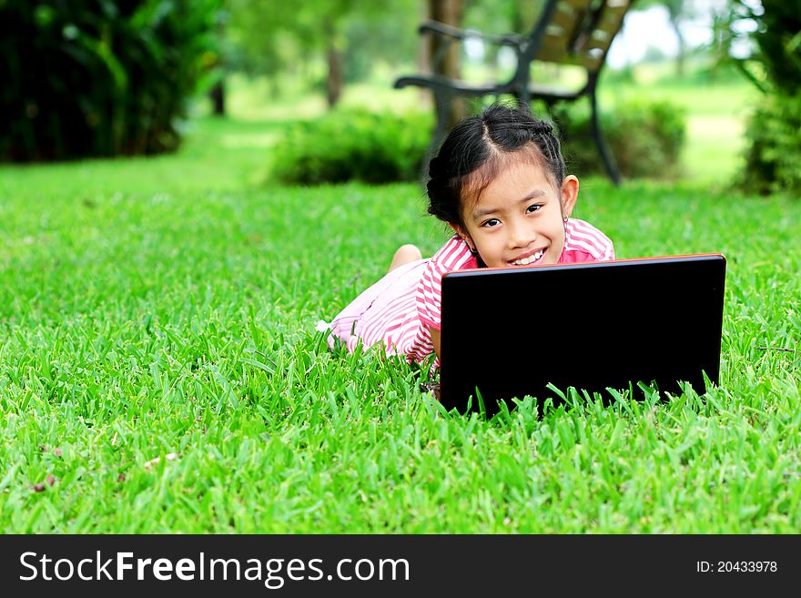 Girl with laptop in the park outside the home. Girl with laptop in the park outside the home