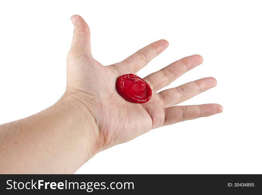 Condom in hand on the white background